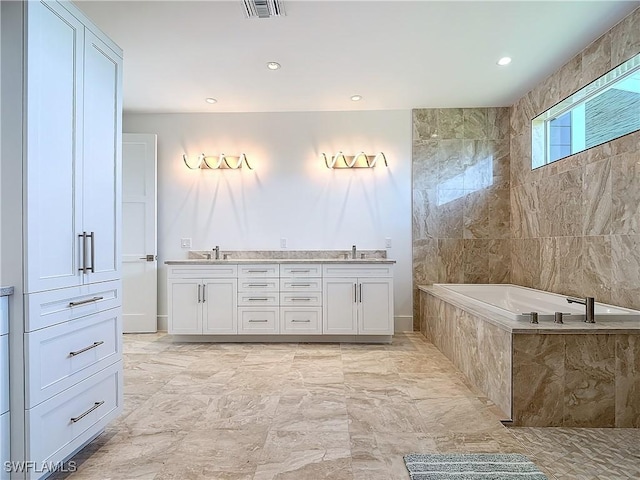 9345 Dimmick Dr, Sanibel, FL 33957 - full bath with visible vents, double vanity, recessed lighting, a bathing tub, and a sink