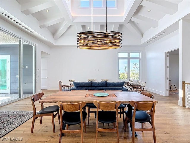 9345 Dimmick Dr, Sanibel, FL 33957 - dining room with baseboards, a notable chandelier, beam ceiling, and light wood-style flooring