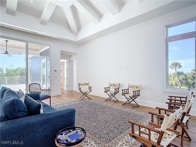 living room featuring beamed ceiling and hardwood / wood-style floors