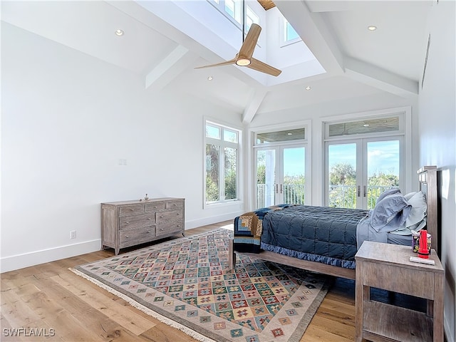 bedroom with french doors, light wood-type flooring, and multiple windows