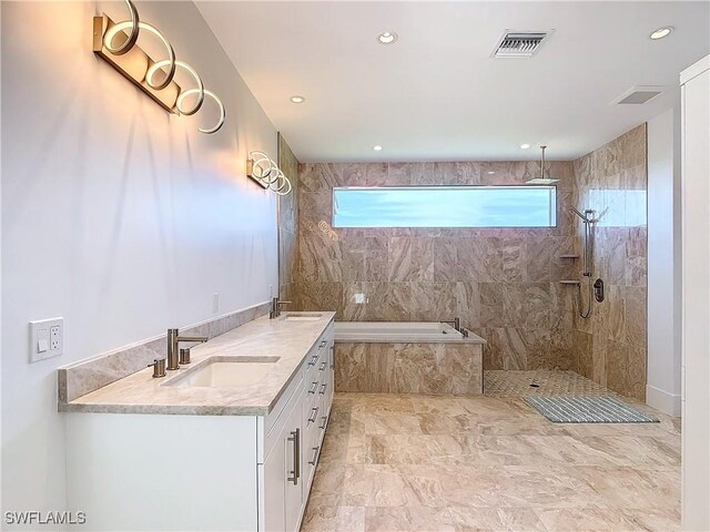9345 Dimmick Dr, Sanibel, FL 33957 - bathroom with a garden tub, visible vents, vanity, a walk in shower, and recessed lighting