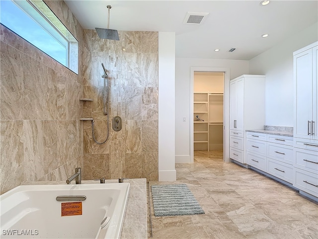 bathroom with shower with separate bathtub