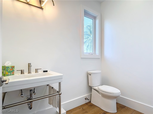 bathroom featuring hardwood / wood-style floors and toilet