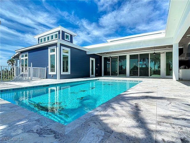 view of pool featuring ceiling fan and a patio