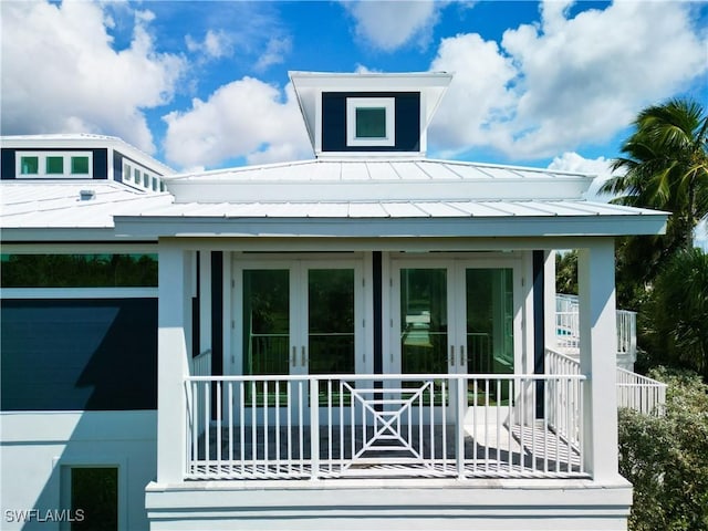9345 Dimmick Dr, Sanibel, FL 33957 - view of side of property with french doors, a standing seam roof, and metal roof