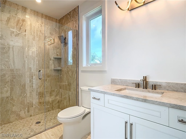 bathroom featuring hardwood / wood-style floors, vanity, toilet, and a shower with shower door