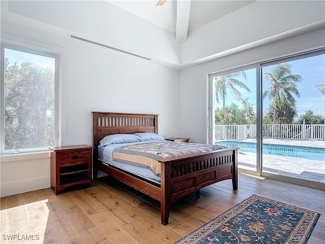 bedroom with light hardwood / wood-style flooring, ceiling fan, and access to exterior