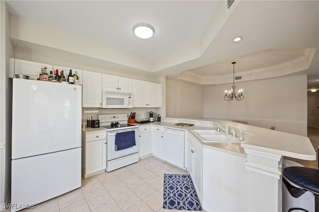 kitchen featuring a sink, white appliances, light tile patterned floors, a raised ceiling, and a peninsula