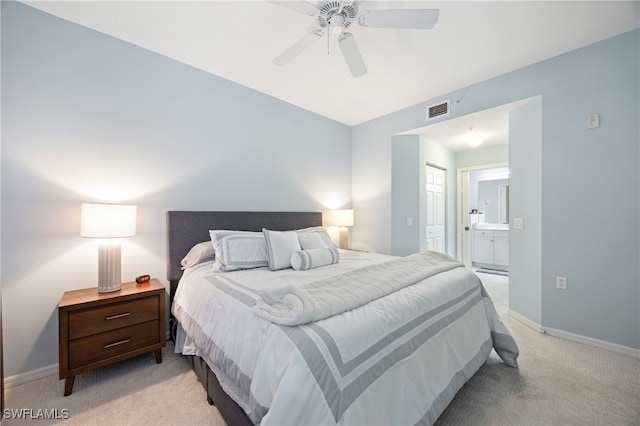 carpeted bedroom featuring ensuite bathroom and ceiling fan