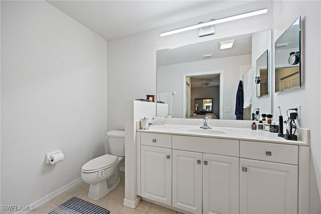 bathroom featuring a ceiling fan, vanity, baseboards, toilet, and tile patterned flooring
