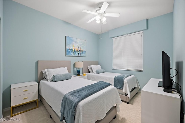 bedroom featuring light colored carpet and a ceiling fan