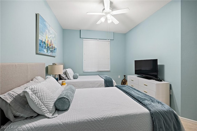 bedroom with ceiling fan, baseboards, and carpet flooring