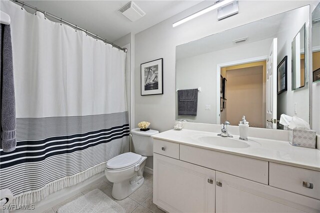 bathroom featuring toilet, vanity, tile patterned floors, and visible vents