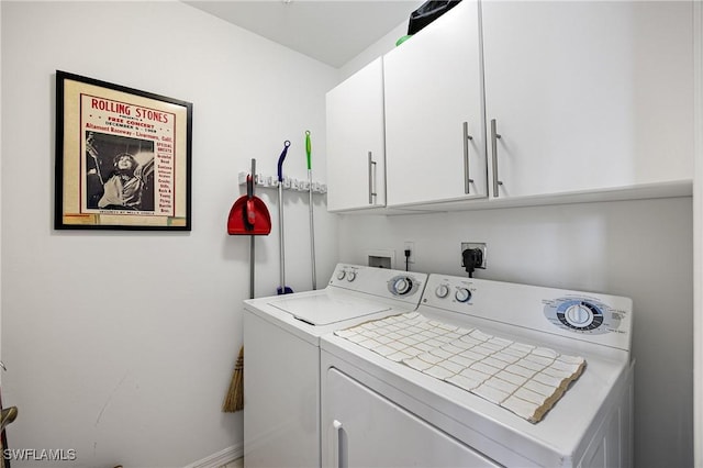 clothes washing area featuring cabinet space and separate washer and dryer