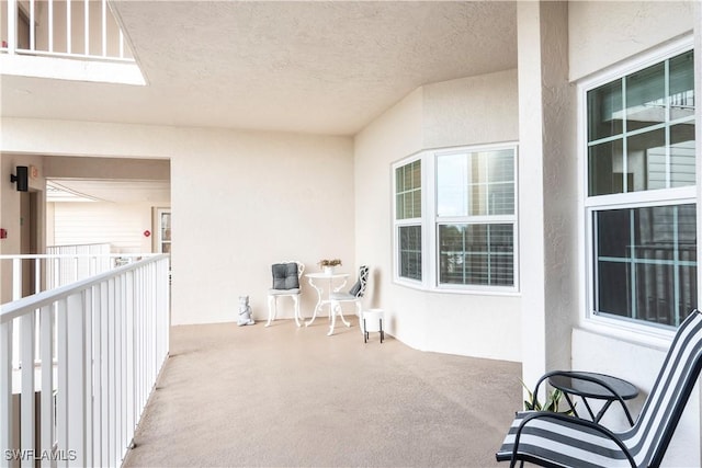 view of patio featuring a balcony