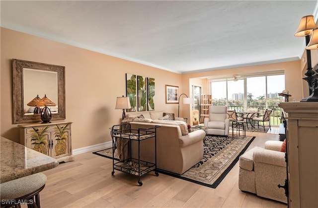 living room with crown molding and light wood-type flooring