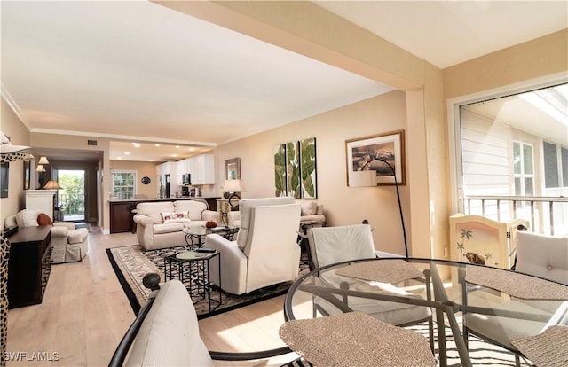 interior space featuring crown molding and light hardwood / wood-style flooring