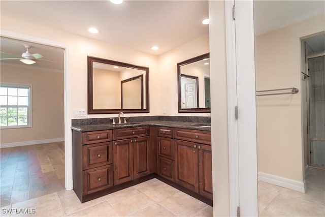 full bathroom with double vanity, a sink, baseboards, ornamental molding, and recessed lighting