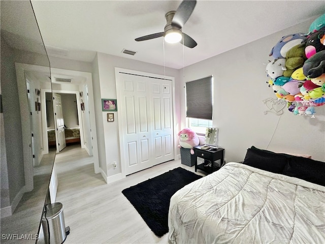 bedroom featuring light hardwood / wood-style flooring, a closet, and ceiling fan