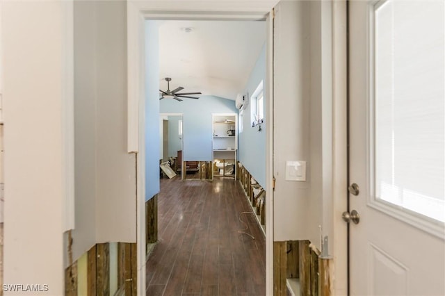 hall with dark wood-type flooring and vaulted ceiling