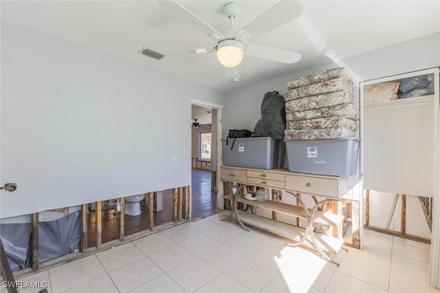 interior space with light tile patterned floors and ceiling fan