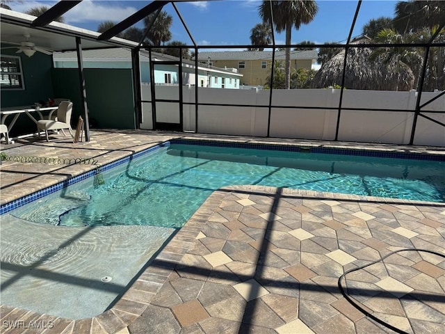 view of pool featuring ceiling fan, a lanai, and a patio area