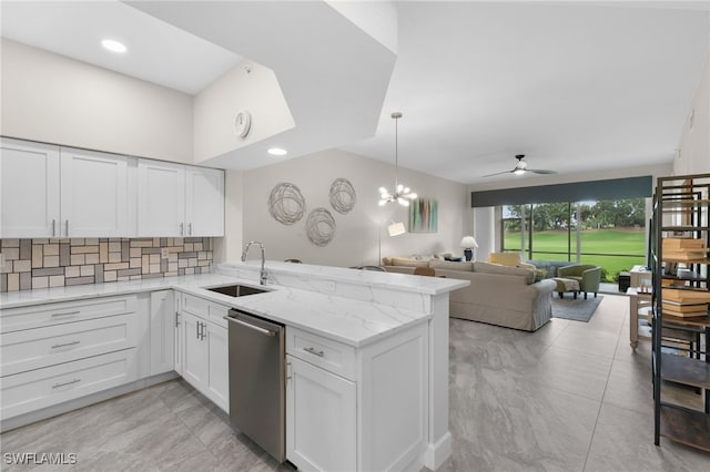 kitchen with sink, kitchen peninsula, white cabinetry, dishwasher, and ceiling fan with notable chandelier