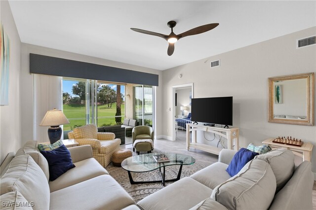 carpeted living room featuring ceiling fan