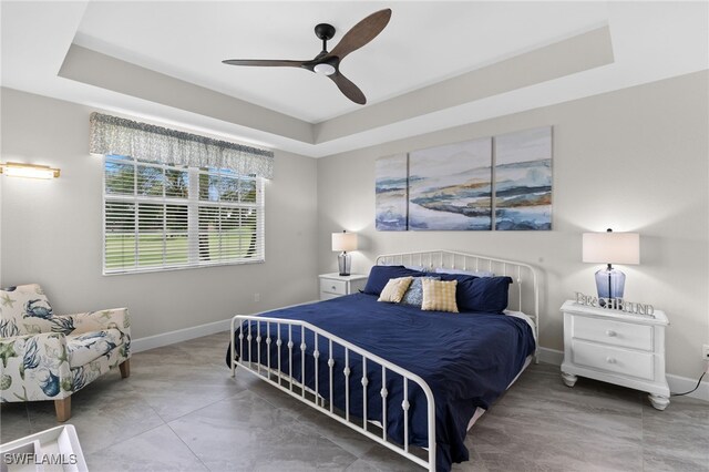 bedroom featuring a tray ceiling and ceiling fan