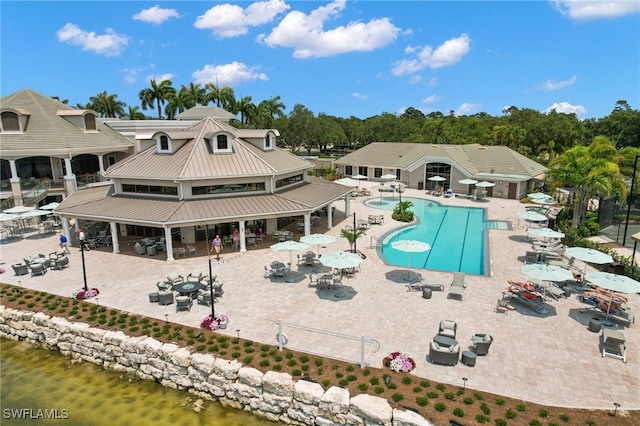 view of pool with a water view, a gazebo, and a patio