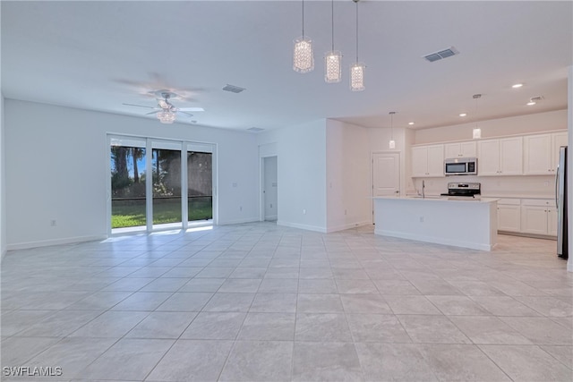 unfurnished living room with ceiling fan and light tile patterned flooring