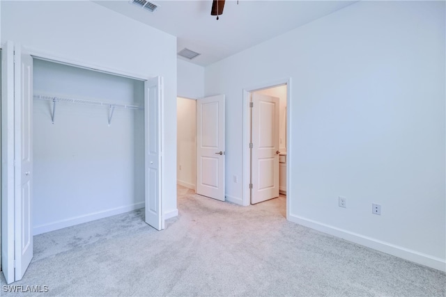 unfurnished bedroom with a closet, ceiling fan, and light colored carpet