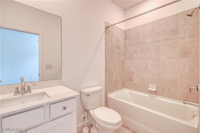 full bathroom featuring vanity, tiled shower / bath combo, and toilet