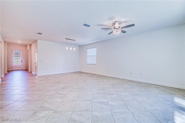 tiled empty room featuring a wealth of natural light and ceiling fan