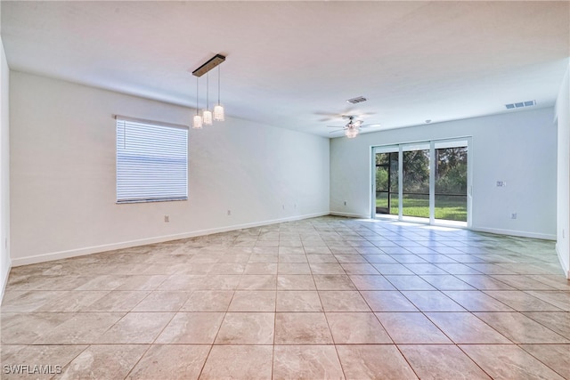 tiled empty room featuring ceiling fan