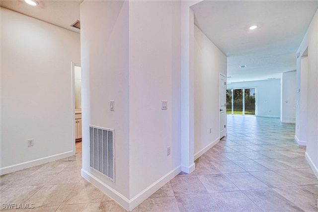 corridor featuring light tile patterned flooring