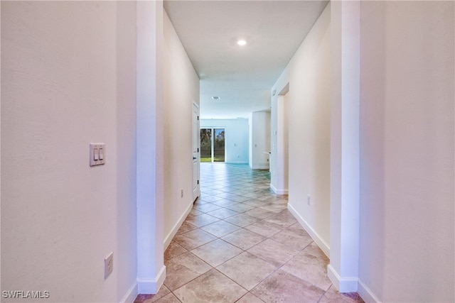 hall with light tile patterned floors