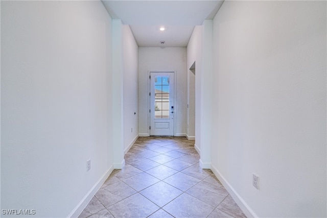 doorway to outside with light tile patterned floors