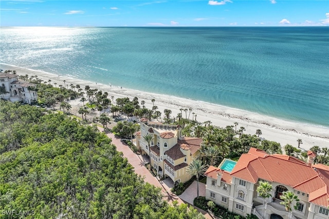 birds eye view of property featuring a water view and a beach view