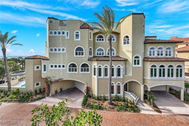 view of building exterior with decorative driveway