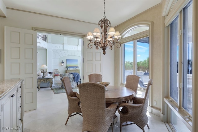 dining space with arched walkways, crown molding, and an inviting chandelier