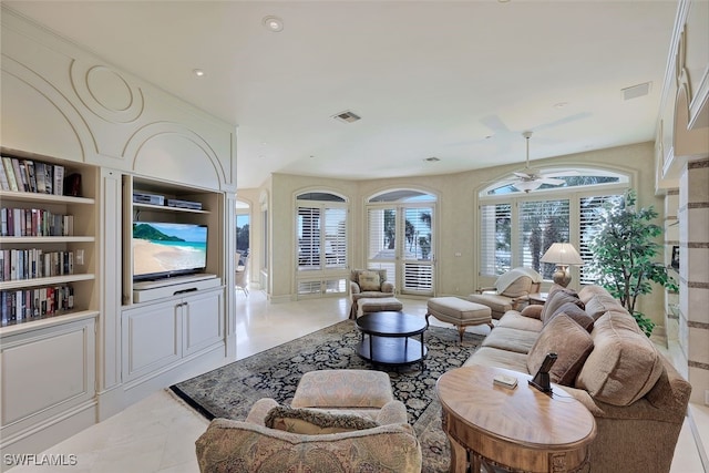 living room with visible vents and a ceiling fan