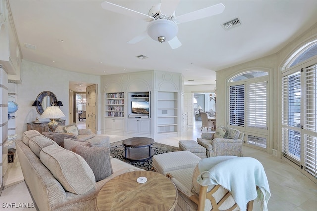 living room with visible vents and a ceiling fan