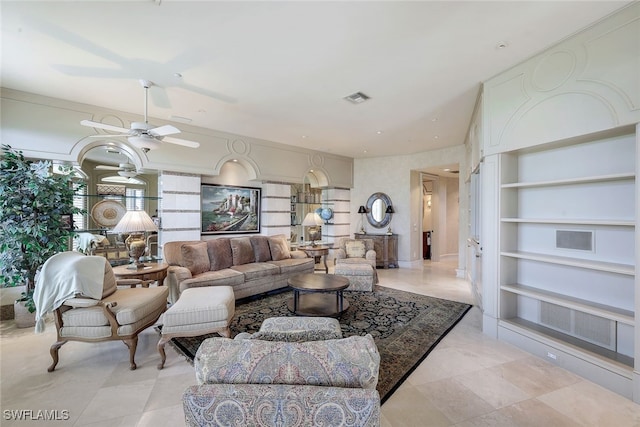 living area featuring ceiling fan, visible vents, and built in features