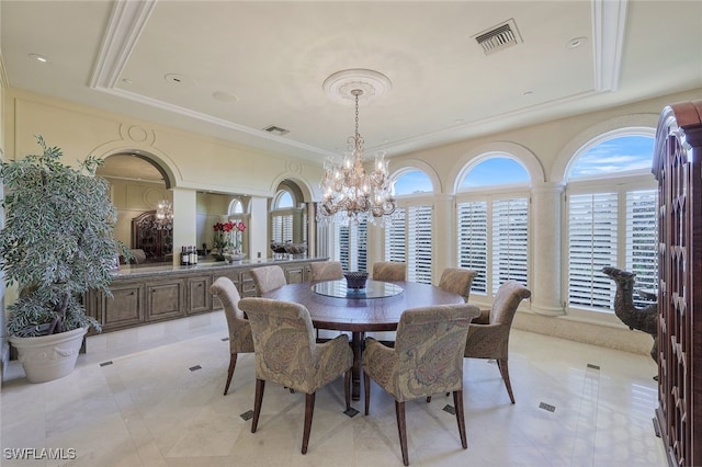 dining space featuring visible vents, a raised ceiling, a notable chandelier, and ornamental molding