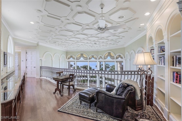 sitting room with ornamental molding, a ceiling fan, recessed lighting, and wood finished floors