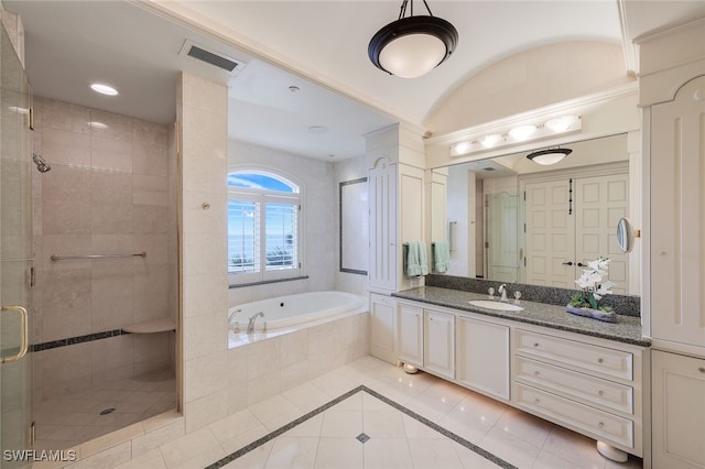 full bath featuring a stall shower, visible vents, a bath, and vanity