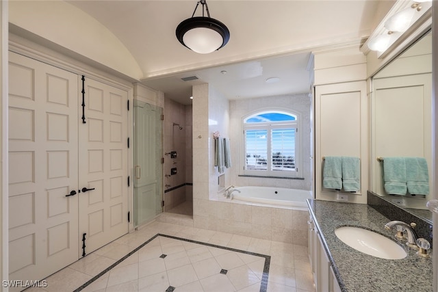 bathroom featuring visible vents, vaulted ceiling, a shower stall, vanity, and a bath