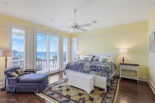 bedroom with access to outside, visible vents, baseboards, and wood finished floors