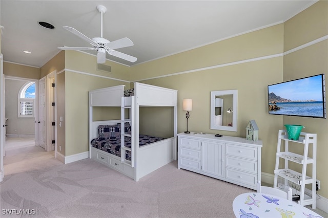 bedroom featuring ornamental molding, light carpet, baseboards, and a ceiling fan